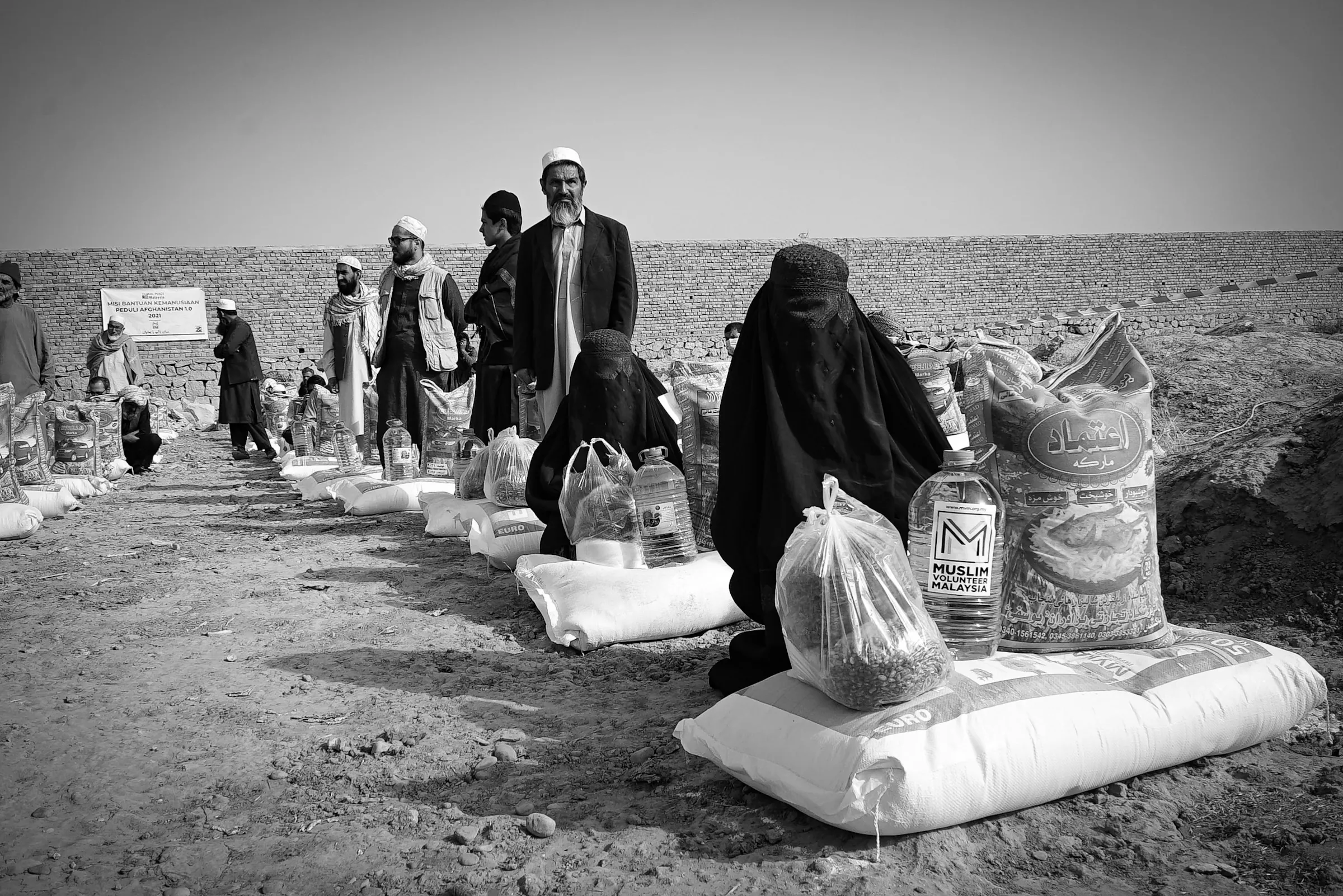 Bags of food and supplies laid out for a community distribution